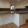 White cabinets with stained maple top on island