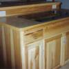 Natural hickory island with flat surface cook top; laminate counter with wood edging