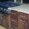 Natural walnut island cabinet with incorporated stove cook top