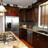 Dark stained cherry kitchen cabinets with crown and rope molding