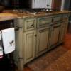 Yellow glazed island cabinet with incorporated stove cook top & granite countertop
