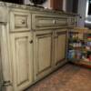 Yellow glazed island cabinet with pull out spice shelving