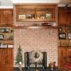 Natural walnut office cabinets with fireplace mantle and glass door cabinet