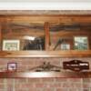 Natural walnut mantle and glass door cabinet