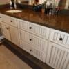 Glazed white vanity with bead board doors & drawer fronts; granite countertop