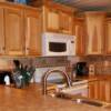 Staggered height natural hickory kitchen cabinets with a step up bar height eating area